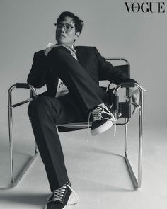 a man sitting in a chair with his legs crossed