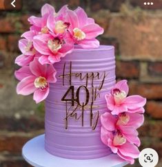 a purple cake decorated with pink flowers and the words happy fortyth birthday written on it