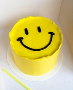 a yellow cake with a smiley face on it