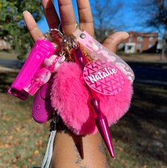 a hand holding several pink items in it's palm, with the word hello kitty written on them