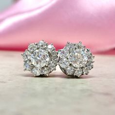 This stunning pair of earrings features a floral design formed by clusters of old European cut diamonds. The center diamonds are GIA-certified as 0.63ct, I color, VVS2 clarity and 0.65ct, I color, SI1 clarity. The total diamond weight of each earring is approx. 1.33ct. These earrings are handcrafted in platinum. ✦ DIAMOND SPECIFICATIONS:    Center Diamond Weight: 0.63 Carats, 0.65 Carats  Center Diamond Color: I Color  Center Diamond Clarity: VVS2, SI1  Center Diamond Cut: Old European Cut  Cert Luxury Diamond White Platinum Cluster Earrings, Luxury Platinum Cluster Earrings In Diamond White, Dazzling Cluster Diamond Earrings For Formal Occasions, Dazzling Cluster Diamond Earrings For Formal Events, Gia Certified Cluster Earrings For Formal Occasions, Elegant Diamond Cluster Earrings Gia Certified, Elegant Gia Certified Diamond Cluster Earrings, Classic Diamond Earrings With Flower Shape And Diamond Accents, Classic Diamond Earrings With Flower Shape