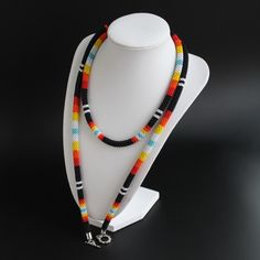 Gift Black Beaded Necklace With Colorful Beads, Black Beaded Necklaces With Colorful Beads For Spiritual Use, Spiritual Black Beaded Necklace With Colorful Beads, Traditional Black Jewelry With Colorful Beads, Spiritual Black Beaded Necklaces With Colorful Beads, Traditional Black Beaded Necklace For Gifts, Black Spiritual Beaded Necklace With Colorful Beads, Large Black Beads For Gifts, Hand-strung Black Beaded Necklaces For Festivals