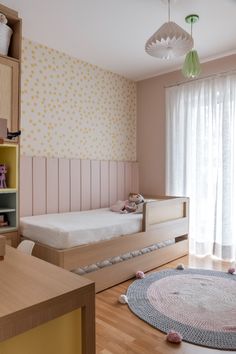 a child's room with two beds and a rug