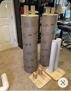 two large rolls of cardboard sitting on top of a floor