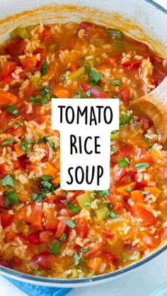 tomato rice soup in a large pot with a wooden spoon on the side that says tomato rice soup