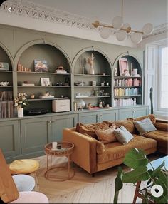 a living room filled with furniture and bookshelves