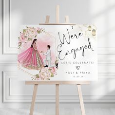 an easel with a wedding card on it and the words, we're engaged