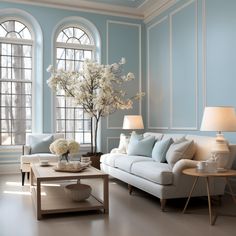 a living room with blue walls and white furniture