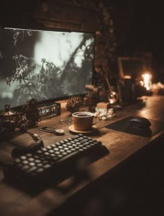 a desk with a keyboard, mouse and monitor on it in front of a lit up screen