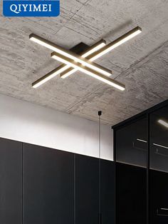 an image of a ceiling light that is in the middle of a room with black cabinets