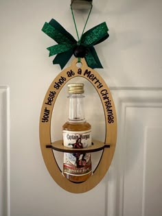 a christmas ornament hanging on a door with a bottle of marmalade