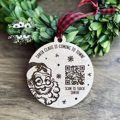 a wooden ornament with a santa clause is coming to town printed on it