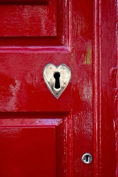 a red door with a heart shaped lock on it