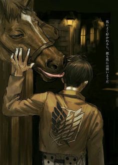 a man standing next to a horse with his face close to the ground and touching it's nose