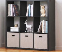 a book shelf with baskets and books on it