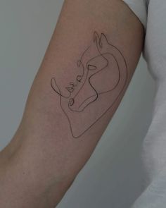 a woman's arm with a line drawing of a cow on the left side of her arm