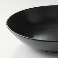 a black bowl sitting on top of a white table