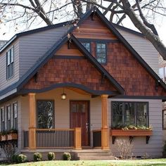 a small house with a large front porch and two windows on the second floor,