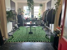 a living room with green and black rugs on the floor