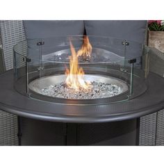 a fire pit sitting on top of a metal table