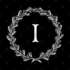 the letter t surrounded by a wreath of leaves and twigs on a black background with white lettering