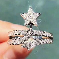 someone is holding two rings in their hand with a star on the top and bottom