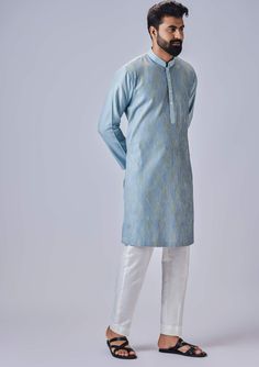 Editor's Note The light blue kurta with multicolor thread and pants is a vibrant and eye-catching ensemble. The kurta features a light blue color with intricate multicolor threadwork, adding a pop of color and texture to the overall design. It is complemented by matching pants, creating a coordinated and stylish look. Fabric: Cotton silk Color: Blue Components: Kurta and pants Occasion: Festive Note: Product colour may slightly vary due to photographic lighting sources Care: Dry clean only About Long Sleeve Multicolor Cotton Silk Kurta, Blue Straight Kurta Sets For Eid, Festive Blue Straight Kurta Pant Set, Blue Salwar Kameez With Chikankari Embroidery For Spring, Blue Cotton Pant Set With Straight Kurta, Spring Blue Salwar Kameez With Chikankari Embroidery, Blue Cotton Silk Kurta For Festivals, Blue Chikankari Embroidery Salwar Kameez For Spring, Multicolor Cotton Silk Kurta For Eid