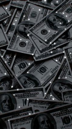 a pile of twenty dollar bills sitting on top of each other with stars in the background