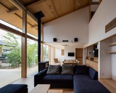 a living room filled with furniture next to a wooden floor covered in lots of windows