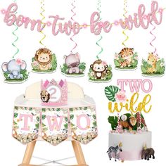 a baby's first birthday party with jungle animals and pink, gold and green decorations