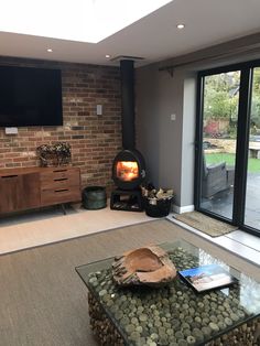 a living room filled with furniture and a fire place in front of a tv mounted on a wall