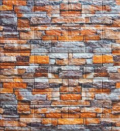 an orange brick wall with grey and brown bricks