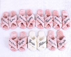 several pairs of pink slippers with names on them