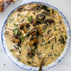 a blue and white bowl filled with mushroom soup