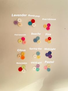 a bunch of different colored buttons on a white surface with words above them that read lavenderr, pink pop, pretty fire, citrus, spring day midnight, watermelon, pastel