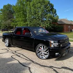 the black truck is parked on the side of the road