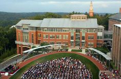 an aerial view of a large building with many people in it and onlookers