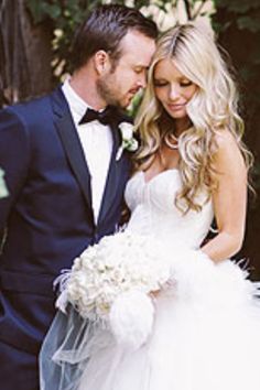 a bride and groom posing for a photo