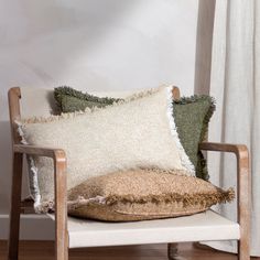 a chair with two pillows on top of it