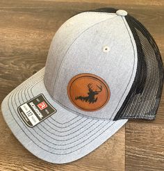 Richardson 112 Hat with Engraved Leatherette Patch Deer Silhouette Engraved on Leatherette Patch Custom Hats Men, Gray Flat Brim Hat For Outdoor Activities, Adjustable Gray Trucker Hat, Gray Flat Bill Hat For Outdoor Activities, Gray Trucker Cap, Gray Curved Bill Hat For Outdoor, Brown Flat Bill Hat As Gift, Gift Brown Flat Bill Hat, Casual Flat Bill Hat Gift