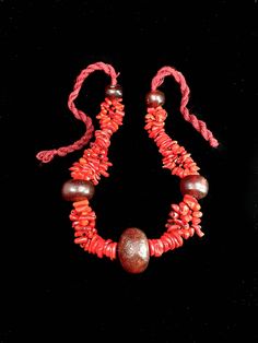 This is an exceptionally rare necklace, crafted from natural red coral beads, carefully separated by beads made from resin extracted from fossilized tree sap. These unique materials are sourced from the southern regions of Morocco, making this necklace a true treasure for those who appreciate authentic and rare jewelry. Please be aware that due to the handmade nature of the items, there might be slight variations in measurements and color. Your understanding is greatly appreciated. Note: Please provide a phone number for a smoother, faster, and safer delivery. You can add this information during checkout or send it to us via direct message. the craftsman's work is never perfect but it remains unique Artisan Red Coral Beaded Necklaces, Traditional Beaded Necklace With Red Coral And Natural Stones, Artisan Red Coral Necklace With Large Beads, Unique Red Coral Beaded Necklaces With Large Beads, Artisan Hand-strung Red Coral Necklace, Bohemian Hand-strung Red Coral Necklaces, Traditional Coral Necklace With Large Beads, Red Fair Trade Jewelry With Round Beads, Artisan Red Coral Necklaces For Jewelry Making