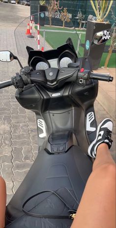 a person riding on the back of a motor scooter