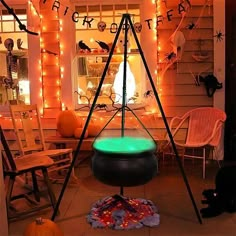 an outdoor halloween decoration with lights and decorations on the front porch, including pumpkins