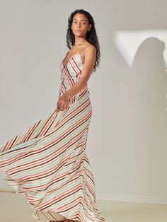 The Bizu Cream Collection is a multi-stripe pattern featuring geometric stripes and dots. Coral, Sky Blue, Terracotta, Pink, and Burgundy create an unexpectedly refreshing combo on a cream background. Cut on a 45-degree bias, the fabric drapes fluidly on the body for an effortless elegant look. With long, tieable spaghetti straps and a back that can be tied in different styles offers a customizable fit. Responsibly-made in Kenya, this silhouette is cut in super-soft sustainable viscose and rayon Terracotta Pink, Blue Terracotta, Blue Tutu, Pink And Burgundy, Plunge Dress, Cream Background, Button Up Dress, Triangle Top, Draped Fabric