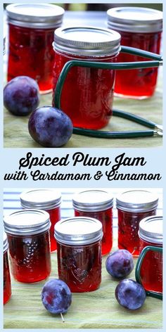 jars filled with plum jam sitting on top of a table