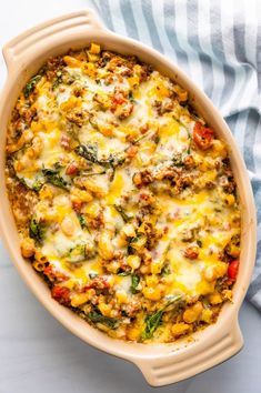 a casserole dish filled with vegetables and cheese