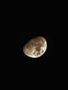 the moon is seen in the dark sky