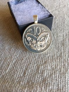 a silver coin sitting on top of a wooden box