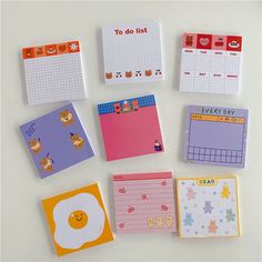 there are many different types of notepads on the table, including one with an egg