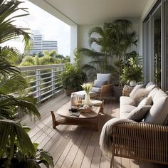 a balcony with couches, tables and potted plants